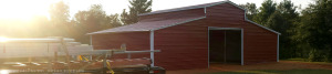 Complete metal barn construction at sunset.