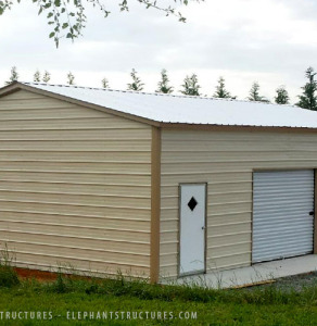 Two car garage with two roll up garage doors and one walk in all on the side.