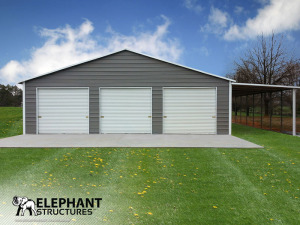 Three roll up garage doors on the front of a steel building used for storage, and an extra lean to on the side.