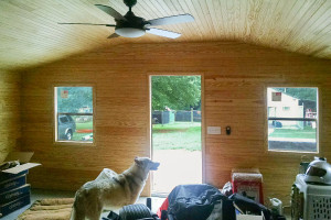 Tiny home from steel building garage with wood paneling on the interior.