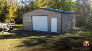 One bay garage metal building with roll up garage door and walk in.